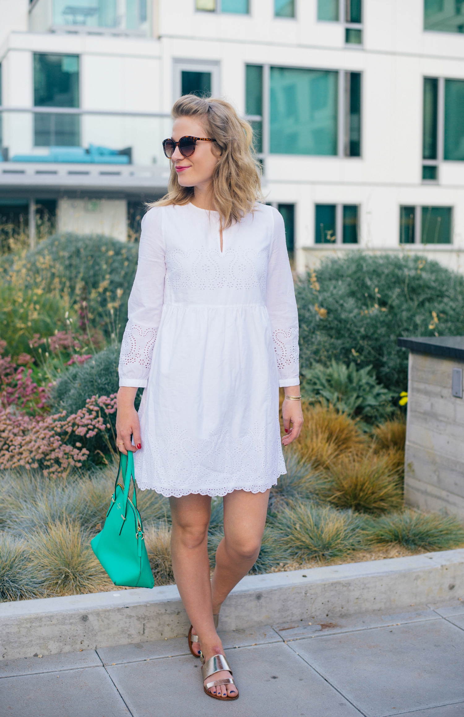 White Eyelet Dress with Green Kate Spade Bag.